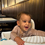 Loann participe au concours pour gagner de l'argent avec cette photo : baby, babylaughing, bodypart, face, finger, furniture, hand, happy, head, indoors, laughing, person, photography, plywood, portrait, restaurant, sitting, smile, tape, wood
