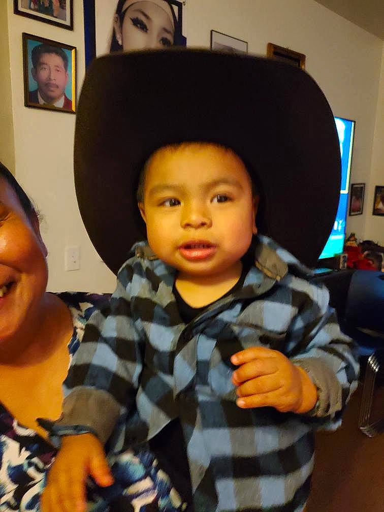 Aaron is registered to the contest to win money with this photo: chair, cheek, child, event, fashion_accessory, fun, hairstyle, happy, hat, pattern, person, picture_frame, plaid, room, sitting, skin, sun_hat, t_shirt, tartan, thumb