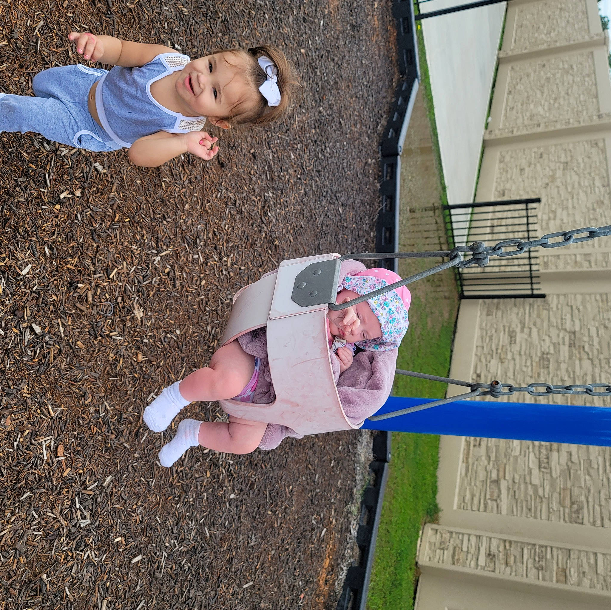 Justice is registered to the contest to win money with this photo: child, concrete, eyewear, foot, fun, grass, headwear, human_leg, joy, landscape, leisure, people_in_nature, person, recreation, shadow, shorts, sitting, soil, thigh, toddler