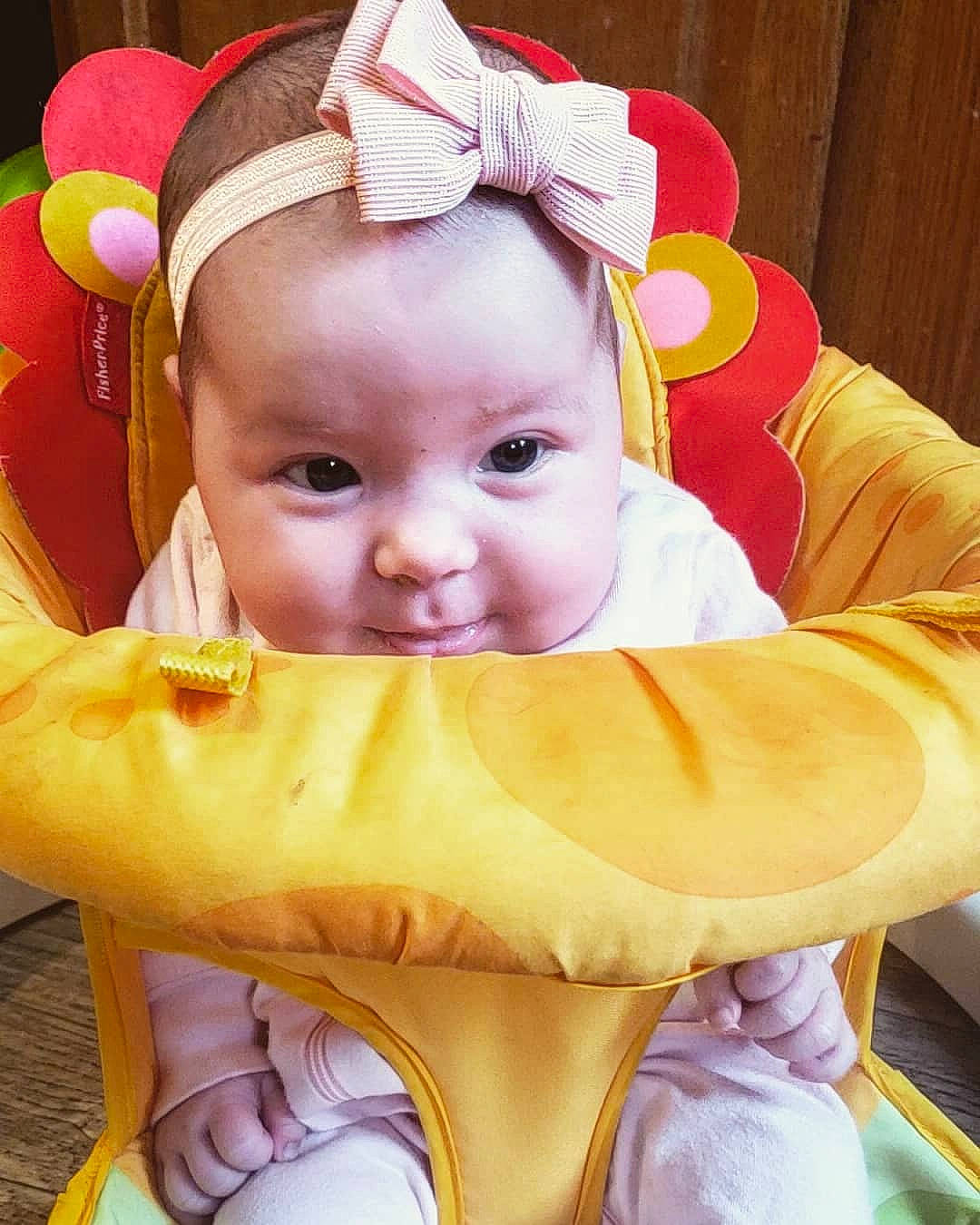 Rylynn is registered to the contest to win money with this photo: baby, baby_products, baby_toddler_clothing, chair, cheek, child, comfort, costume_hat, eye, facial_expression, fun, happy, head, lap, mouth, person, pink, skin, smile, toddler