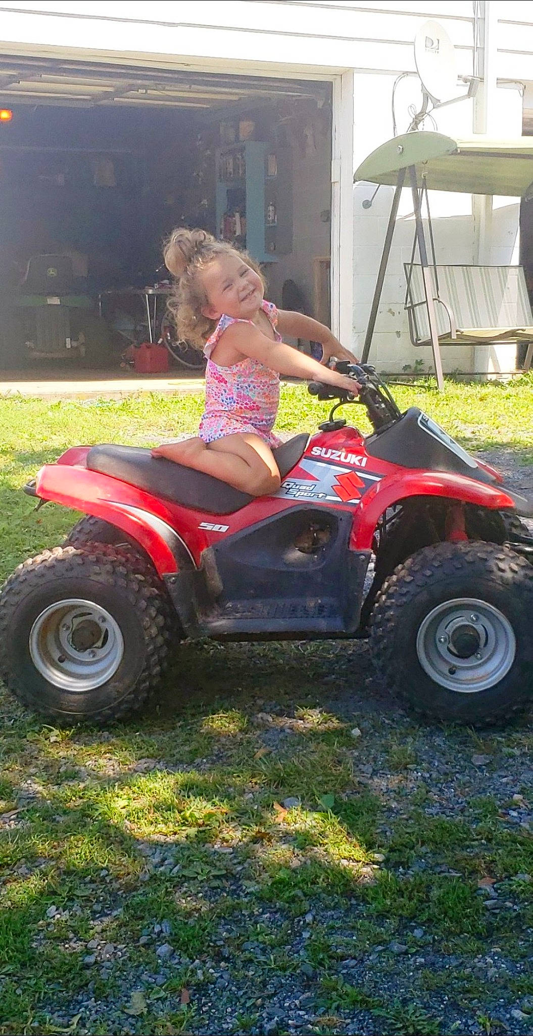 Marlayna is registered to the contest to win money with this photo: alloy_wheel, automotive_design, automotive_exterior, automotive_tire, bumper, car, fender, grass, hood, hubcap, joy, motor_vehicle, person, plant, recreation, riding_toy, rim, shorts, tire, tread