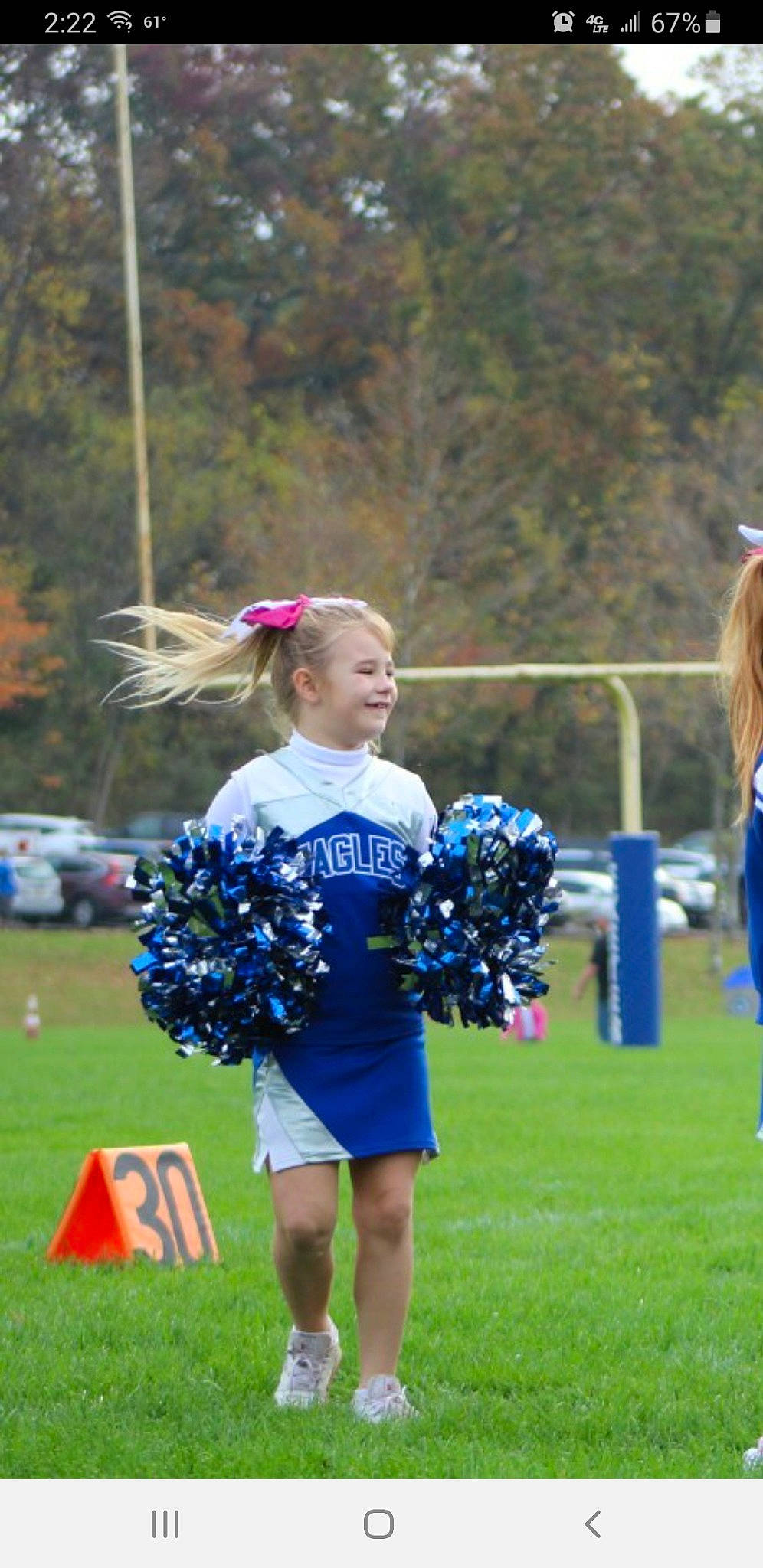 Myla joined the competition — help win amazing prizes! championship, cheerleading, cheerleading_uniform, competition_event, electric_blue, event, fun, grass, joy, person, plant, player, pole, recreation, smile, sports, street_fashion, team, team_sport, tire