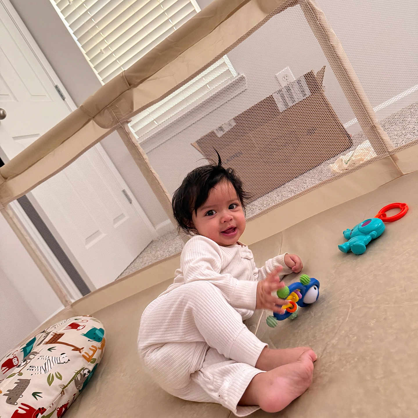 Arjun Panhasak joined the competition — help win amazing prizes! baby, child, indoor, playpen, toy, pajamas, floor, cushion, window, smile, face, person, home, carpet, door, light, colorful, cute, happy, infant