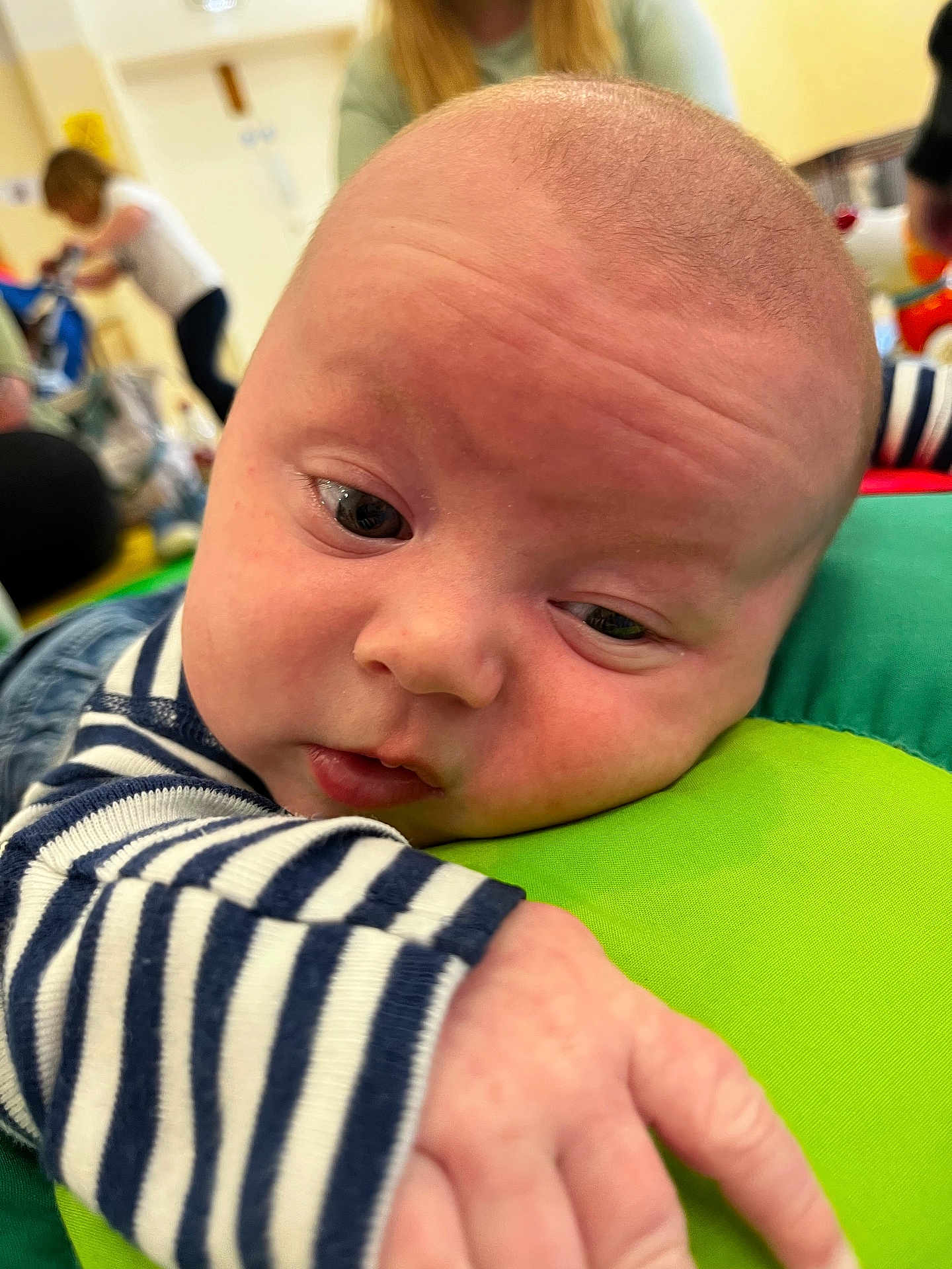 Arthur joined the competition — help win amazing prizes! baby, infant, close_up, face, hand, striped_clothing, green_cushion, indoor, child, person, curious, resting, soft_light, background_blur, people, casual, expression, young_child, early_childhood, candid