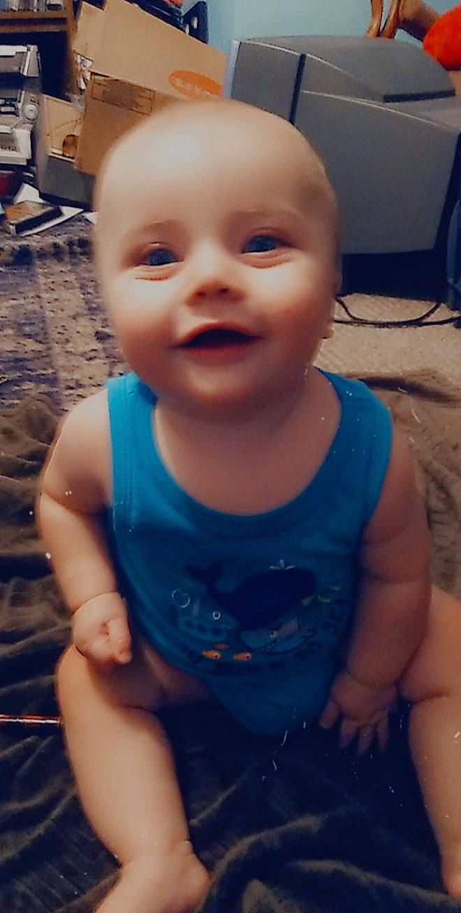 Bryson is registered to the contest to win money with this photo: azure, baby_toddler_clothing, black, cheek, chin, eyebrow, face, facial_expression, hairstyle, head, human_body, iris, joy, lip, mouth, muscle, nose, organ, person, skin