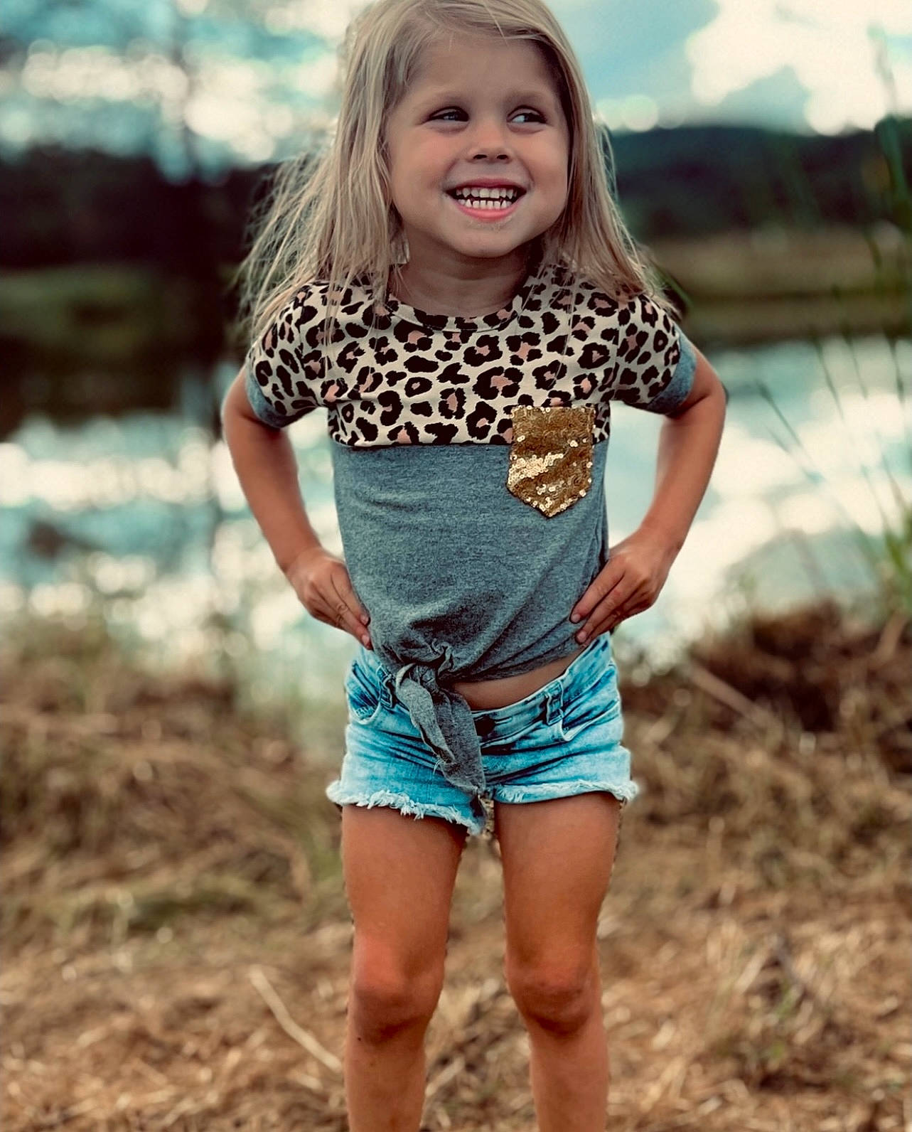 Hailee is registered to the contest to win money with this photo: denim, face, grass, happy, human_body, human_leg, joy, knee, leg, long_hair, neck, pattern, people_in_nature, person, shorts, shoulder, sleeve, smile, t_shirt, thigh