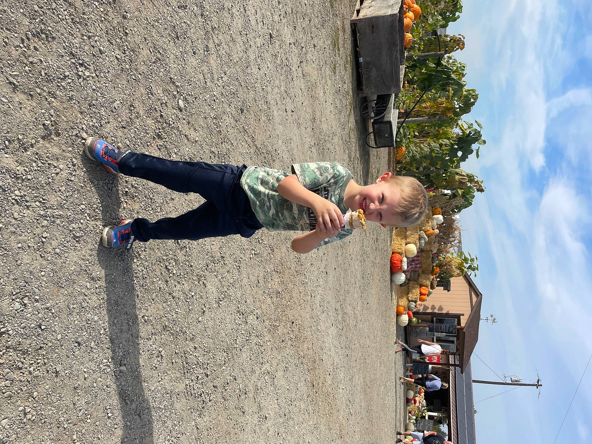 Jaron is registered to the contest to win money with this photo: adventure, asphalt, cloud, concrete, fun, human_leg, joy, leisure, outdoor_shoe, people_in_nature, person, plant, recreation, shadow, shorts, sky, street_light, toddler, tree, vacation