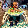 baby, walker, toy, indoor, smile, child, clothing, floor, carpet, furniture, socks, head, face, play, happy, seat, colorful, infant, person, living_room