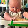 baby, infant, high_chair, toy, hand, foot, face, skin, clothing, bib, tape, table, indoors, child, cute, expression, sitting, furniture, focus, background_blur