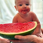 Heath is registered to the contest to win money with this photo: baby, background, closeup, curious, cute, expression, face, food, fresh, fruit, hand, healthy, infant, juice, mouth, person, sitting, skin, summer, watermelon