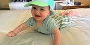 Heath is registered to the contest to win money with this photo: arms, baby, bed, bedroom, cap, child, clothing, crawling, cute, face, furniture, happy, headwear, indoor, lamp, legs, pajamas, person, smiling, striped