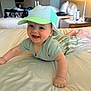 baby, smiling, cap, bed, indoor, child, clothing, person, happy, face, arms, legs, furniture, lamp, bedroom, striped, pajamas, headwear, crawling, cute