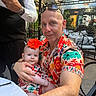Antonia joined the competition — help win amazing prizes! baby, child, father, adult, portrait, restaurant, outdoor_dining, table, waiter, flower, hibiscus, floral_shirt, sunglasses, smiling, cuddling, family, chair, glass_windows, sunlight, selfie