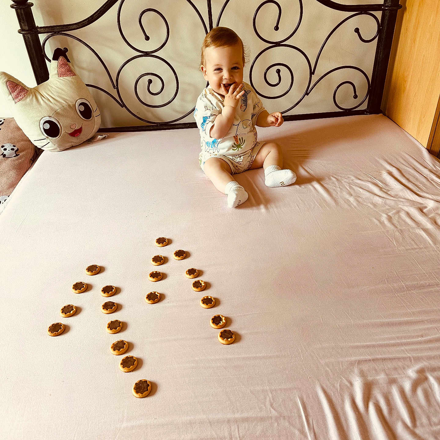 Arti is registered to the contest to win money with this photo: baby, bed, bedroom, blanket, cat_pillow, child, cookies, cute, decor, furniture, happy, indoor, infant, pattern, pillow, playful, sheet, sitting, smiling, toy