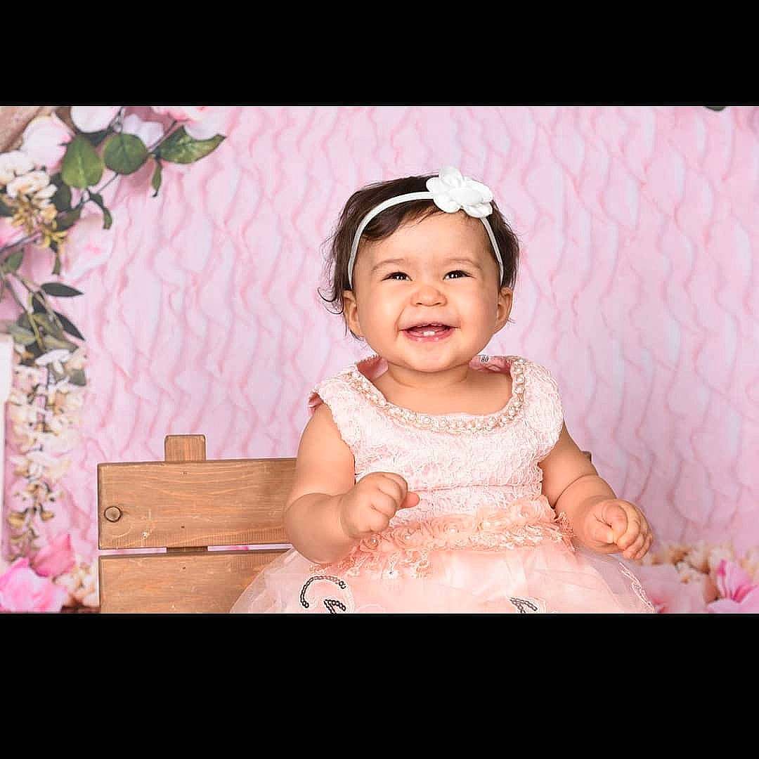 Xiomara joined the competition — help win amazing prizes! baby, beauty, cheek, child, dress, eye, face, facial_expression, hair_accessory, happy, head, headpiece, human, person, photograph, photography, pink, skin, smile, snapshot