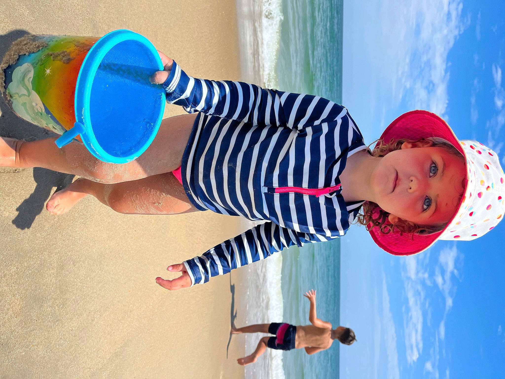 Audriana joined the competition — help win amazing prizes! arm, azure, blue, child, elbow, electric_blue, fun, happy, hat, headgear, headwear, leisure, person, product, sky, sleeve, smile, standing, thigh, toddler