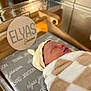 Elyas is registered to the contest to win money with this photo: newborn, baby, blanket, hat, sleeping, hospital, bassinet, bed, infant, cozy, resting, child, person, soft, cute, portrait, warm, wrapped, indoor, name_sign
