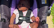 Linda Marie is registered to the contest to win money with this photo: baby, child, stroller, car_seat, butterfly_pattern, sunlight, outdoor, infant, safety_harness, cute, person, purple, pink, grass, footwear, seat, seatbelt, toddler, summer, daylight