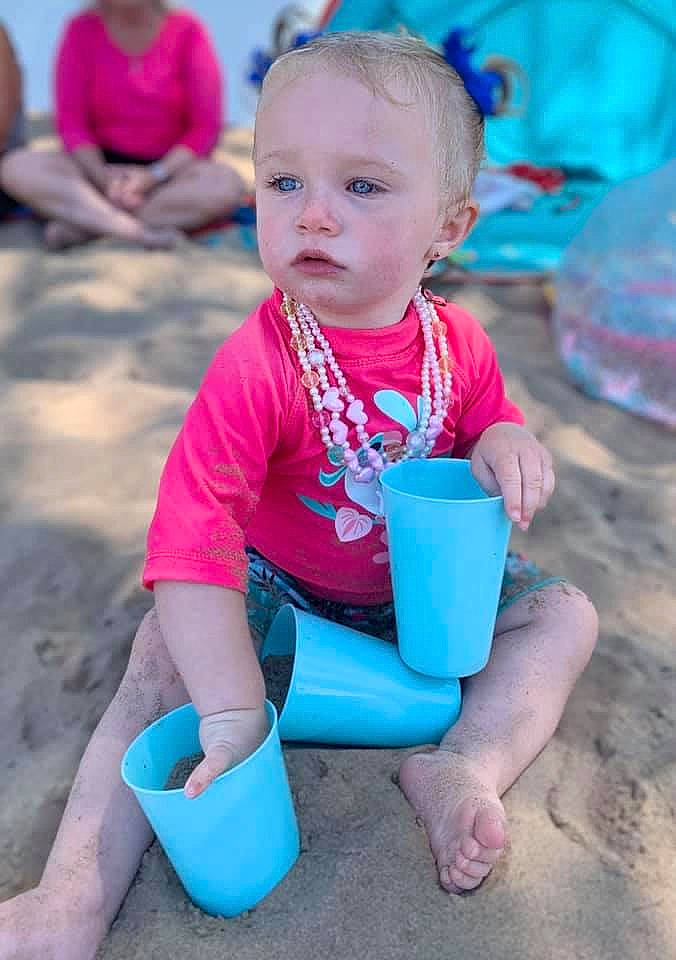 Mila is registered to the contest to win money with this photo: baby, baby_toddler_clothing, blue, child, fun, hairstyle, happy, leisure, magenta, people, person, photograph, pink, purple, recreation, red, sand, snapshot, summer, toddler