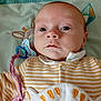 baby, infant, face, eyes, clothing, striped, pacifier, blanket, soft_toy, cute, child, lying_down, closeup, indoors, adorable, young, expression, comfort, fabric, head