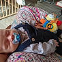 Marius participe au concours pour gagner de l'argent avec cette photo : baby, sleeping, pacifier, plush_toy, lion_toy, patterned_fabric, overalls, checkered_shirt, infant, indoor, crib, toy, resting, hand, foot, colorful, cozy, cute, child, person