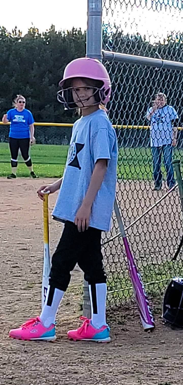 Lilyann joined the competition — help win amazing prizes! ball_game, baseball_bat, competition_event, electric_blue, fence, football_helmet, fun, grass, headwear, helmet, jersey, person, personal_protective_equipment, player, shorts, sports, sports_equipment, sports_gear, sports_uniform, stick_and_ball_sports