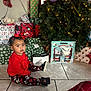bow, child, christmas_tree, curious, cute, decorations, festive, gift_wrap, holiday, holiday_spirit, home, indoors, lights, portrait, presents, red_clothing, sitting, tile_floor, toddler, toy
