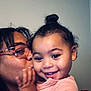 Patience is registered to the contest to win money with this photo: child, toddler, smile, happy, face, person, adult, glasses, kiss, affection, love, hair_bun, indoor, skin, closeup, portrait, casual, clothing, family, bonding