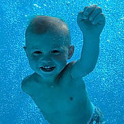 Ethan participe au concours pour gagner de l'argent avec cette photo : bathingsuit, blue, boy, bubbles, child, cute, diaper, fun, happy, motion, playful, pool, portrait, skin, smiling, summer, swimming, toddler, underwater, water