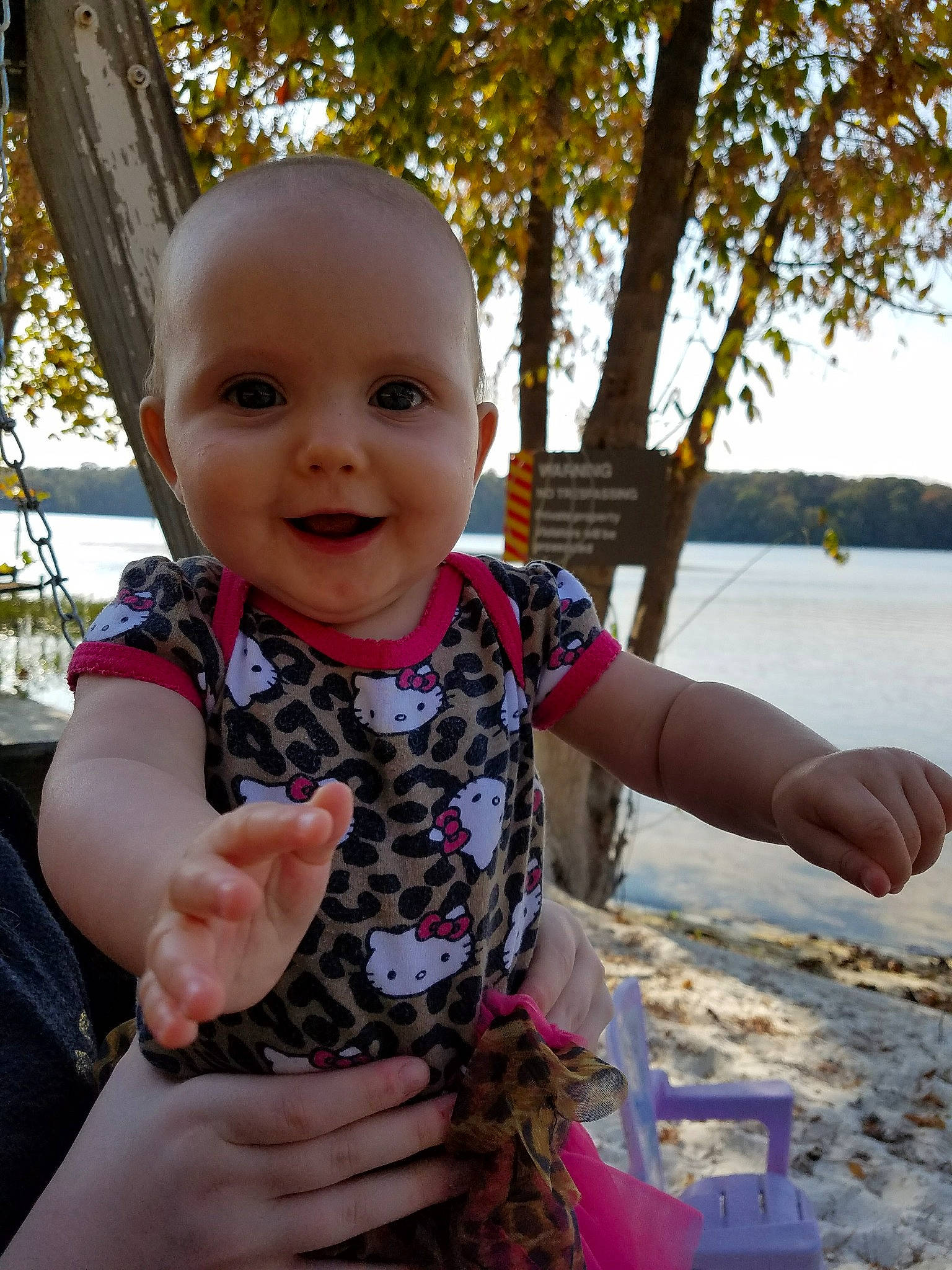 Amberly is registered to the contest to win money with this photo: baby, baby_toddler_clothing, cheek, eye, finger, fun, gesture, hand, happy, joy, leisure, person, skin, sky, sleeve, smile, summer, thumb, toddler, travel
