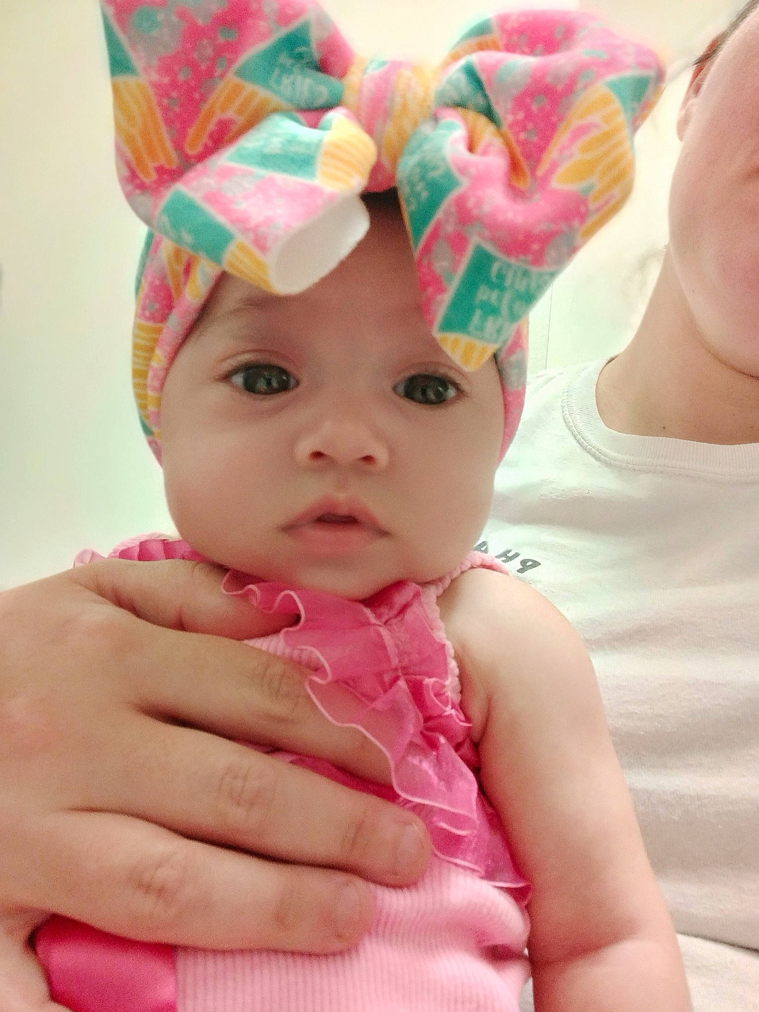 Gabrielle is registered to the contest to win money with this photo: baby, baby_toddler_clothing, cap, cheek, child, costume_hat, facial_expression, finger, fun, gesture, happy, headgear, headpiece, headwear, magenta, party_supply, person, pink, product, skin