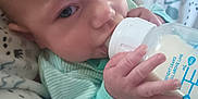 Joey joined the competition — help win amazing prizes! baby, bottle, feeding, blanket, infant, hand, clothing, face, milk, person, newborn, cute, sleepwear, nursery, child, rest, closeup, soft, indoors, cozy
