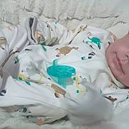 Joey is registered to the contest to win money with this photo: baby, infant, onesie, pacifier, blanket, soft, cute, animal_prints, sleepwear, lying_down, portrait, child, young, cozy, indoor, face, expression, human, baby_clothes, smile
