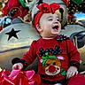 Miracle is registered to the contest to win money with this photo: baby, child, smiling, red_clothing, headband, holiday, christmas, decorations, jingle_bells, bow, festive, outdoor, happy, cute, seasonal, celebration, portrait, holiday_outfit, joyful, infant