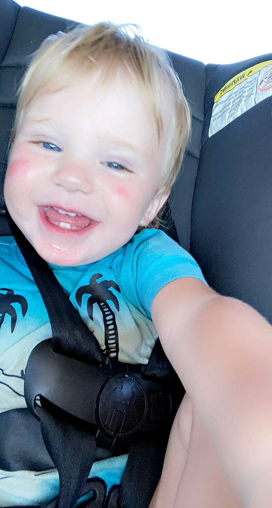 Taysom is registered to the contest to win money with this photo: arm, baby, baby_in_car_seat, baby_toddler_clothing, blue, cheek, comfort, cool, eyelash, facial_expression, flash_photography, hand, happy, human_body, iris, joy, mouth, neck, person, skin