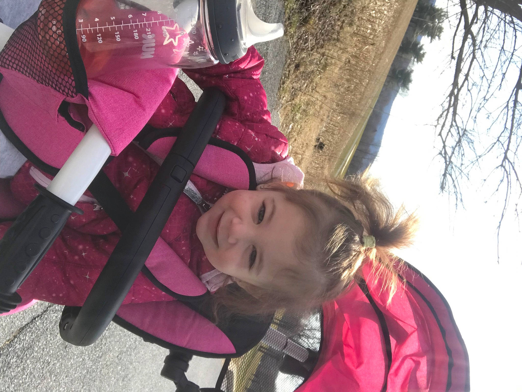 Nia is registered to the contest to win money with this photo: carmine, child, fashion_accessory, freezing, fun, happy, hoodie, joy, leisure, magenta, person, pink, recreation, red, scarf, smile, snow, toddler, tree, winter