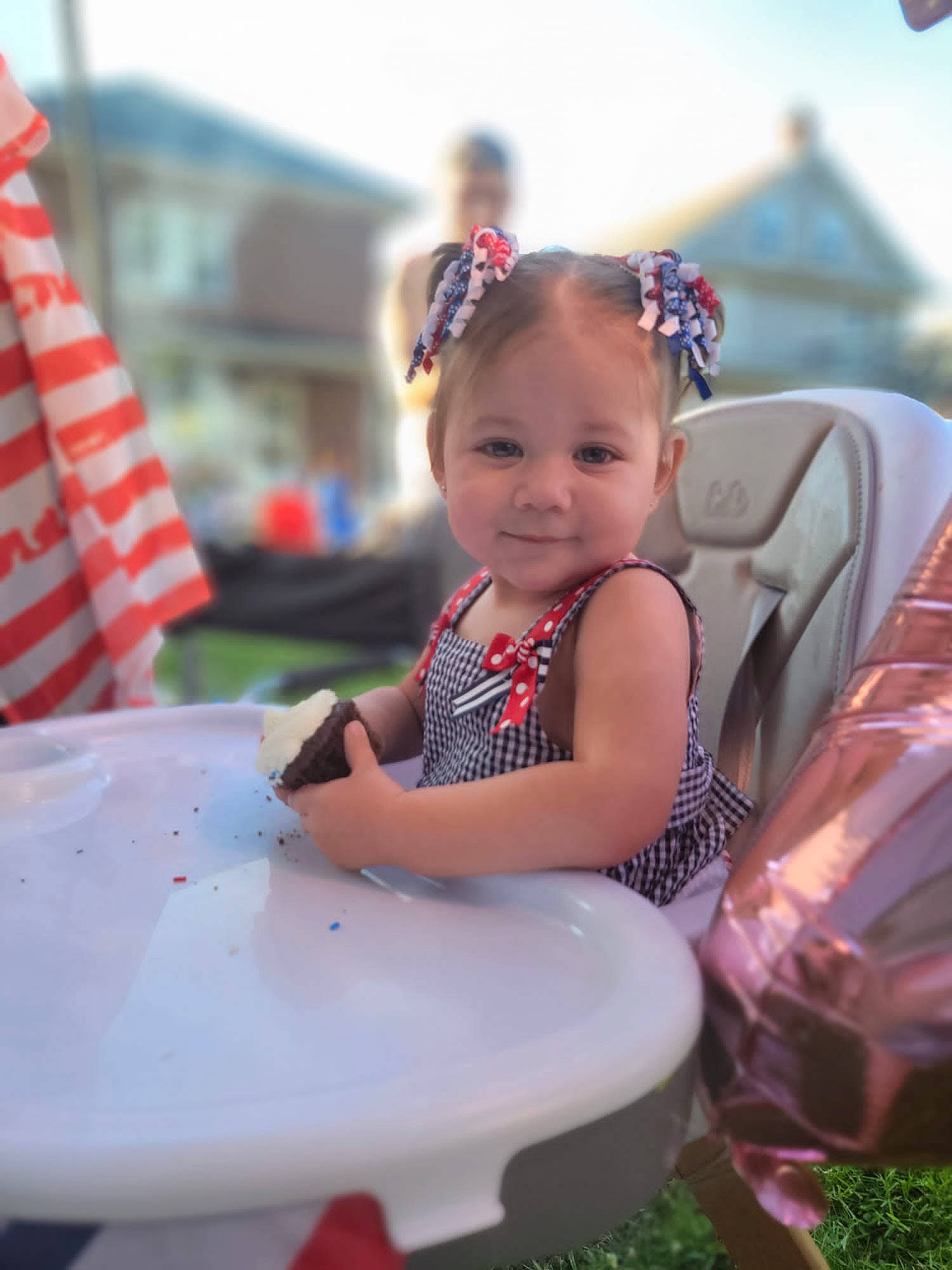 Nia joined the competition — help win amazing prizes! baby, child, dress, event, eye, face, fun, grass, hairstyle, happy, human_body, joy, leisure, person, pink, recreation, sitting, skin, sky, smile