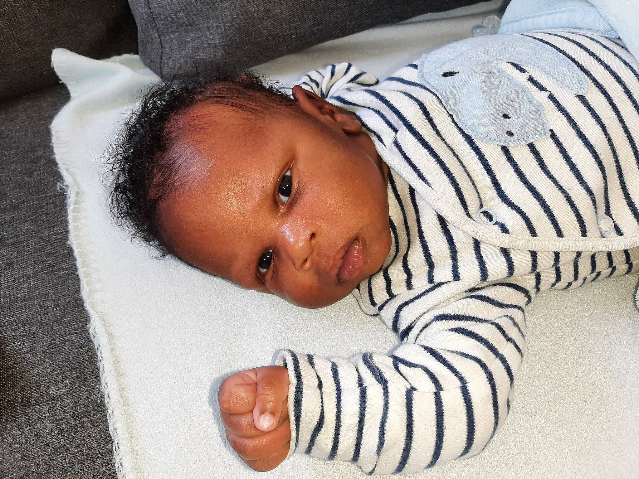 Tyler participe au concours pour gagner de l'argent avec cette photo : baby, baby_toddler_clothing, cheek, child, comfort, eye, eyebrow, facial_expression, head, human_body, iris, linens, lip, mouth, nose, person, room, skin, sleeve, textile