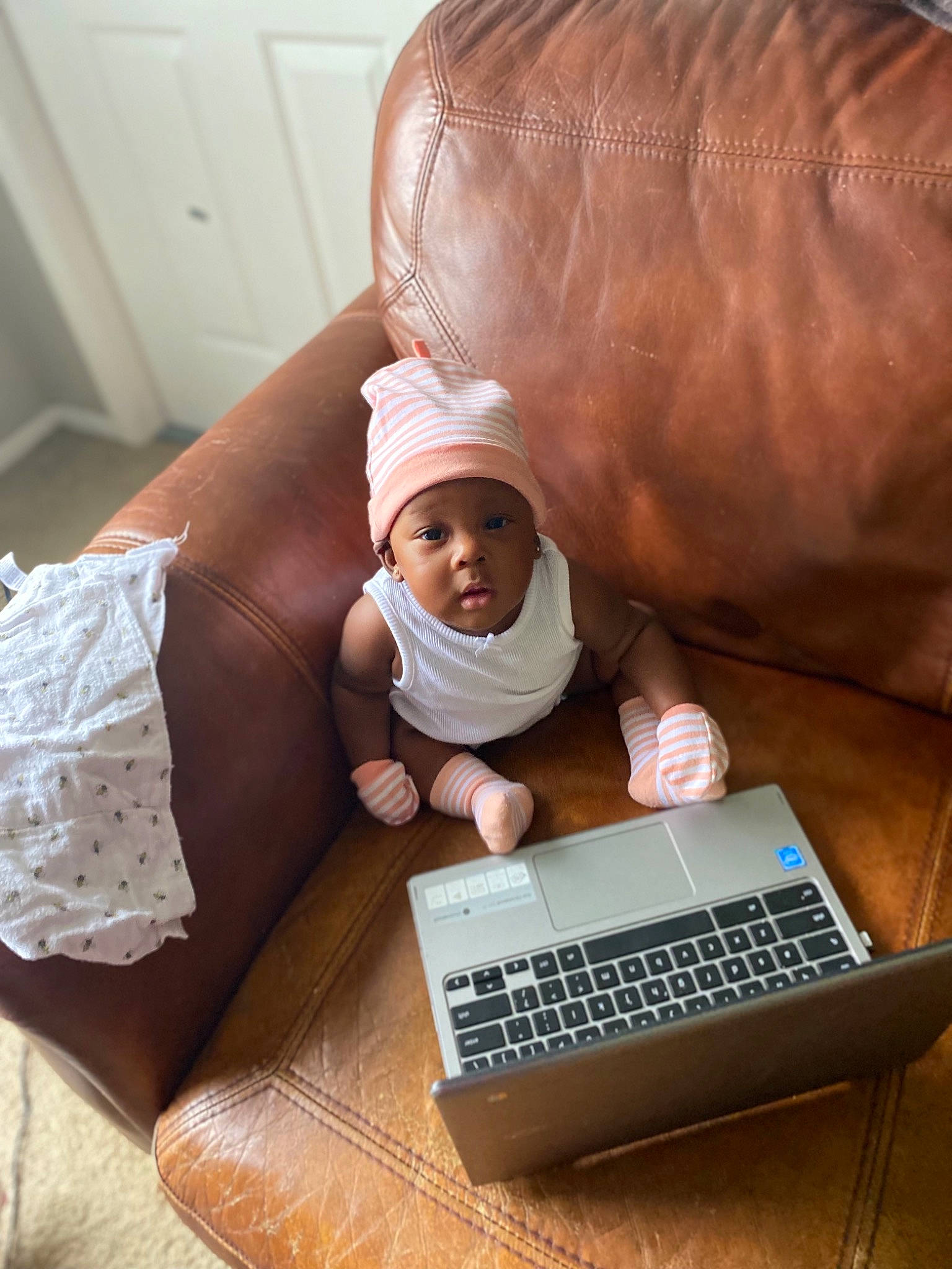 Kaylie is registered to the contest to win money with this photo: baby, comfort, computer, computer_hardware, couch, finger, flooring, glasses, hand, headwear, input_device, laptop, leg, netbook, office_equipment, person, personal_computer, pillow, space_bar, thigh