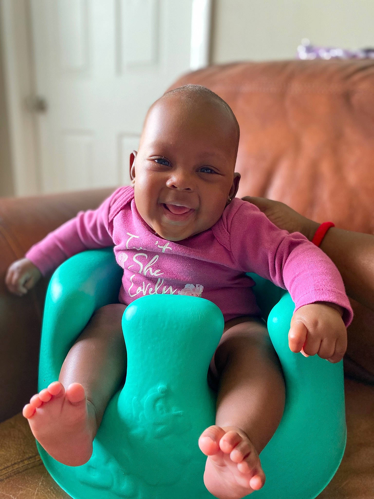 Kaylie is registered to the contest to win money with this photo: arm, baby, baby_toddler_clothing, comfort, face, facial_expression, finger, gesture, hand, happy, head, leg, leisure, people, person, pink, shoe, skin, smile, thigh