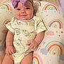 Laylah is registered to the contest to win money with this photo: baby, child, infant, headband, bow, onesie, owl_print, cushion, rainbow_pattern, smile, happy, cute, indoors, person, skin, hand, legs, seated, fabric, soft