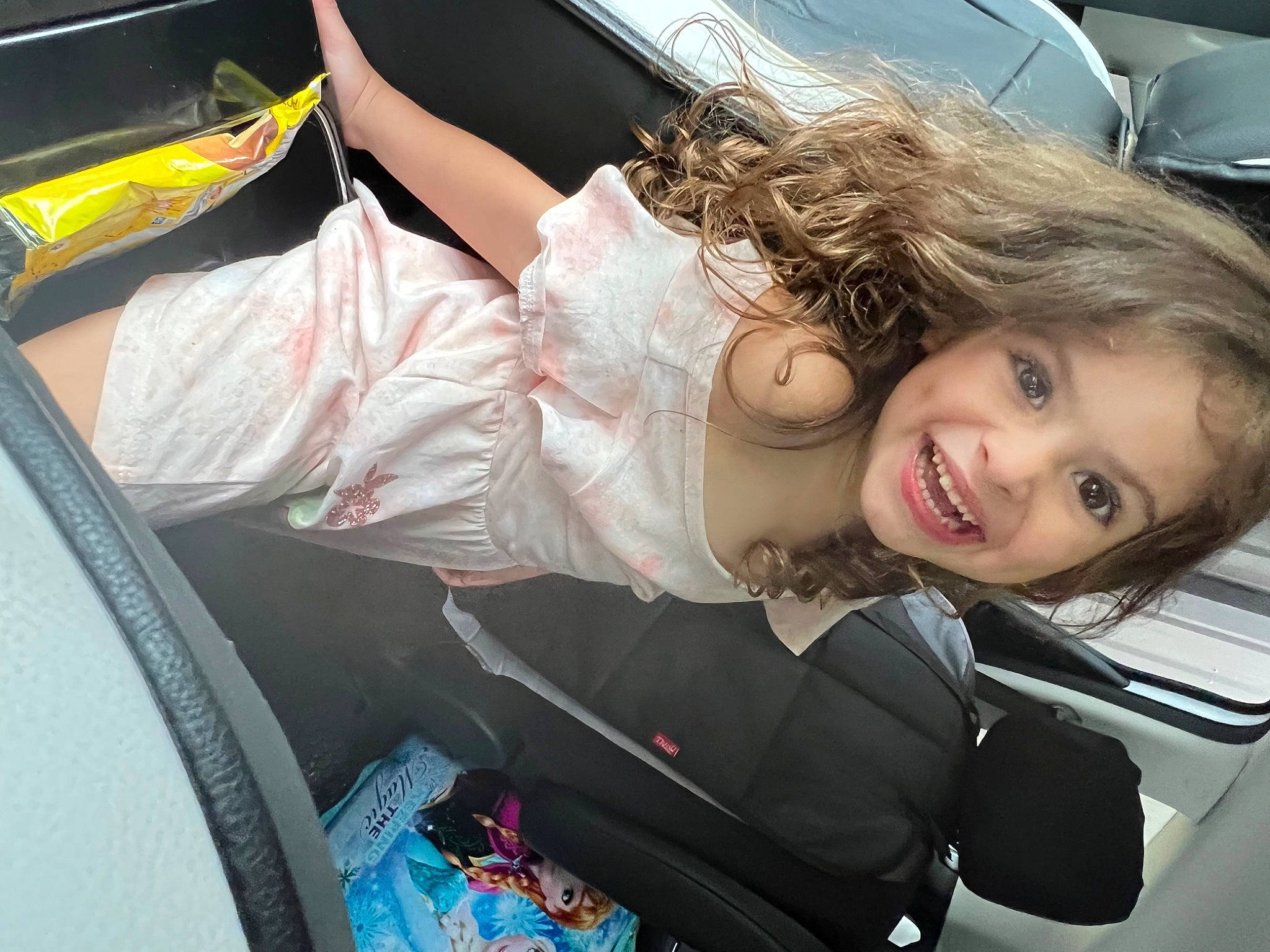 Sarai is registered to the contest to win money with this photo: auto_part, automotive_design, automotive_exterior, automotive_lighting, automotive_wheel_system, baby_carriage, bumper, car_seat, eye, face, fun, happy, human_leg, joy, long_hair, motor_vehicle, person, personal_luxury_car, smile, steering_wheel