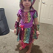 Alaiya Mary Deeter joined the competition — help win amazing prizes! child, barefoot, colorful_clothing, dress, hood, indoor, carpet, curious, person, standing, arm_cuffs, patterned, rainbow, heart_prints, young, girl, door, laundry_basket, home, casual
