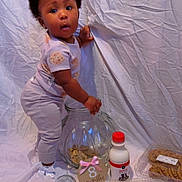 Amonii joined the competition — help win amazing prizes! 8_months_sign, baby, bottle, child, clothing, container, cookie, cookie_jar, curious, cute, food, hair_clip, indoor, milk, person, portrait, snack, standing, wrinkled_backdrop, young_child