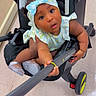 Amonii is registered to the contest to win money with this photo: baby, black_stroller, blue_bow, child, curious, cute, floor, floral_outfit, grip, headband, indoor, infant, person, playful, selfie_stick, shoes, sparkly_shoes, stroller, wide_eyes, young_child