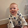 Alfie is registered to the contest to win money with this photo: baby, child, smiling, sitting, star_pattern, clothing, wooden_floor, indoor, happy, infant, face, cute, person, young, wall, power_outlet, long_sleeves, feet, hands, casual