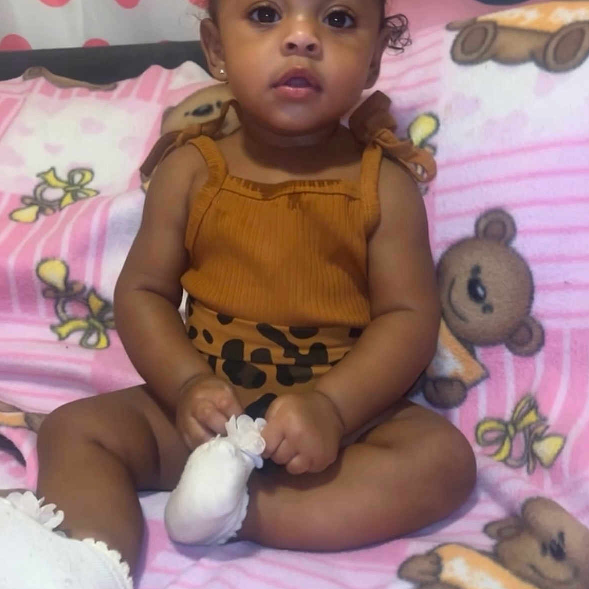 Shanilyn joined the competition — help win amazing prizes! baby, child, toddler, infant, sitting, blanket, teddy_bear, bow, clothing, white_socks, cute, curious, indoors, portrait, pink, brown, small_bow, person, young_child, soft