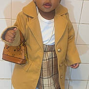 Shanilyn joined the competition — help win amazing prizes! toddler, child, fashion, coat, plaid_skirt, boots, handbag, indoor, tiles, portrait, cute, brown_hair, accessories, standing, young_child, floor_mat, jewelry, white_shirt, black_tights, small_bag