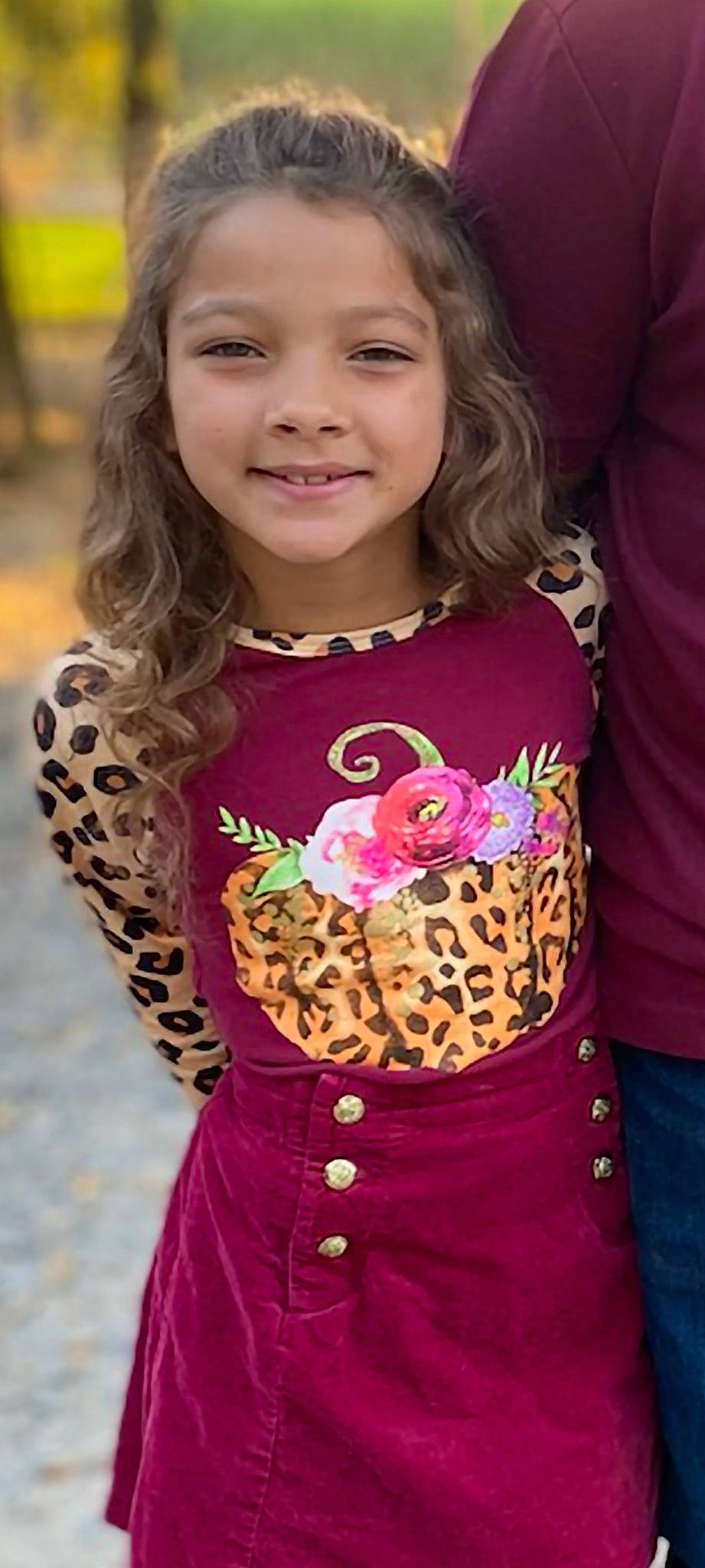 Mallie is registered to the contest to win money with this photo: beauty, brown_hair, child, cool, face, facial_expression, hairstyle, happy, joy, long_hair, magenta, neck, organ, pattern, person, pink, skin, sleeve, smile, t_shirt