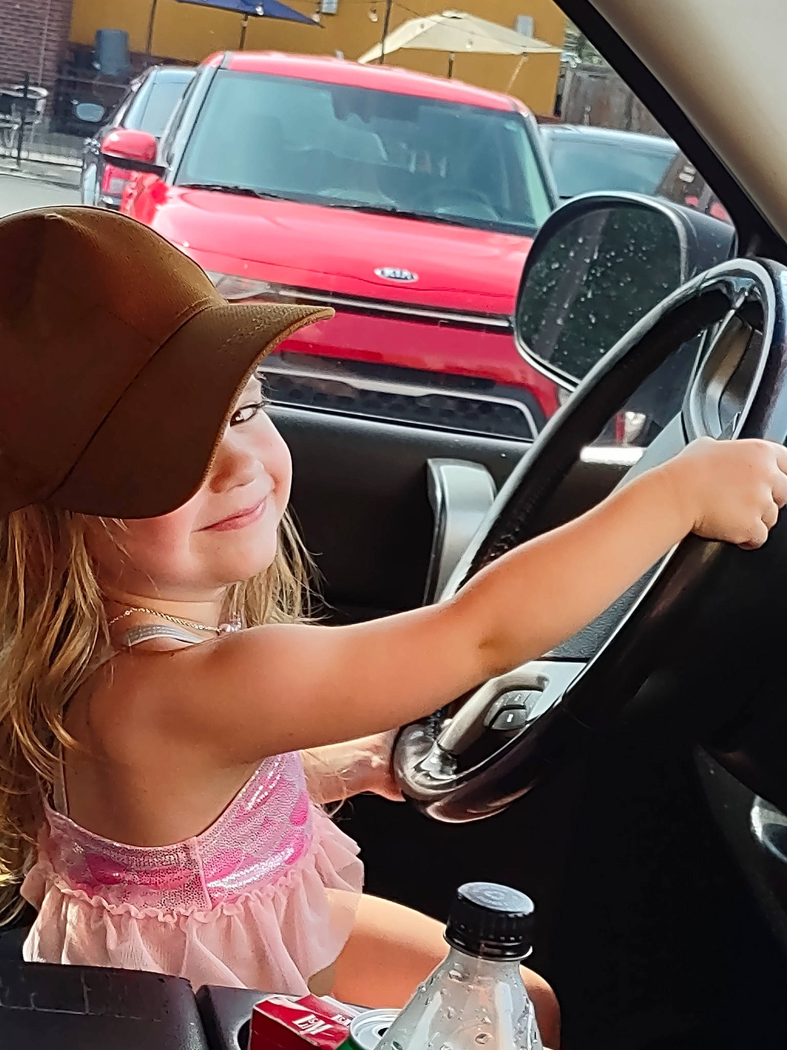 Aurora is registered to the contest to win money with this photo: auto_part, automotive_design, automotive_exterior, automotive_lighting, automotive_wheel_system, baseball_cap, bottle, car, event, family_car, hood, human_leg, luxury_vehicle, motor_vehicle, person, personal_luxury_car, rim, steering_wheel, vehicle, vehicle_door